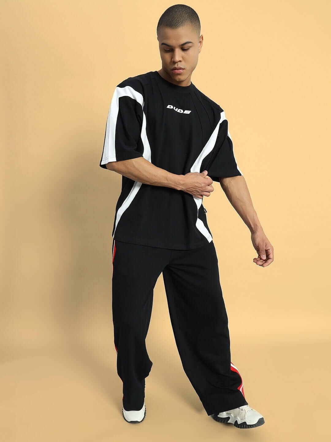 MILANO RELAXED-FIT COTTON JOGGERS BLACK-RED Model wearing Milano Relaxed-Fit Joggers in black-red, showcasing stylish and comfortable design by DUDS, available for custom fit.