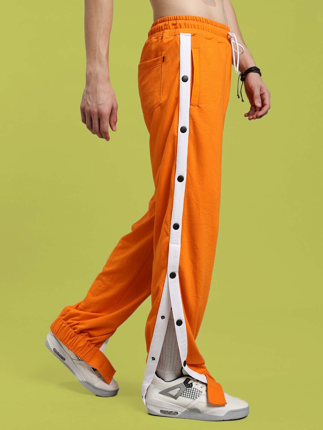 MILLER RELAXED FIT JOGGERS ORANGE with side buttons, showcasing modern streetwear fashion for comfort and style.