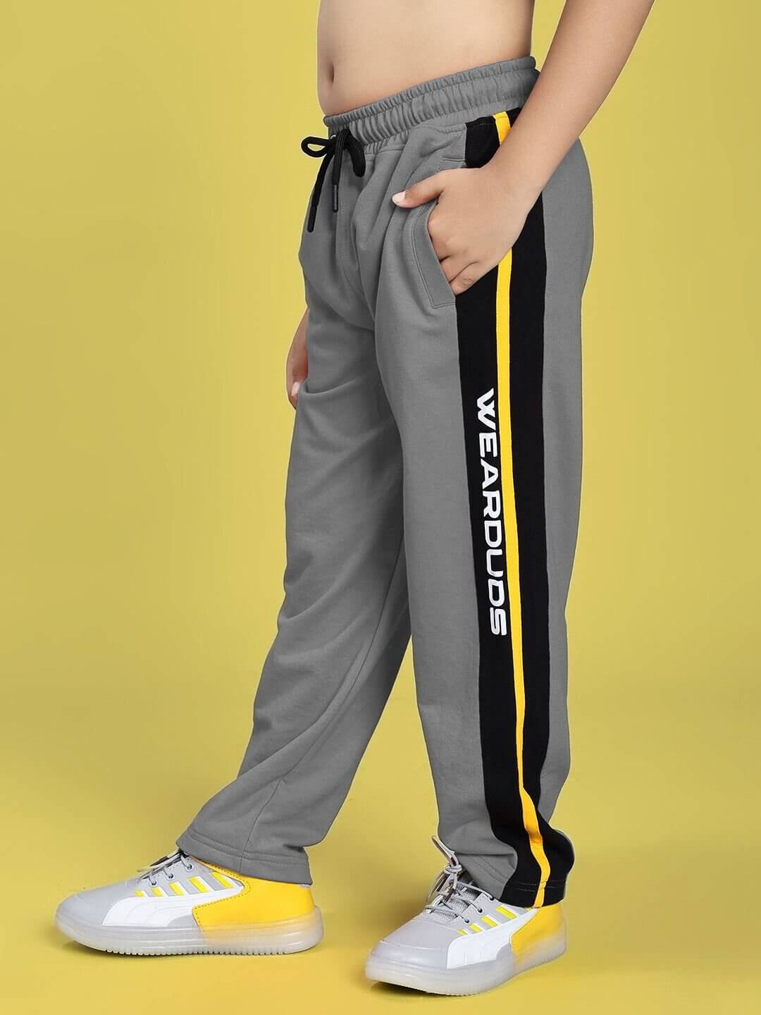 Child wearing MINING THE MOONLIGHT PRINT CO-ORD FOR BOYS GIRLS BLACK GREY with side stripe detail on pants.
