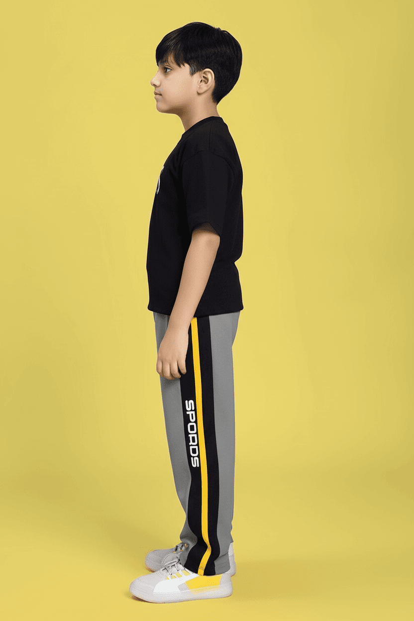 MINING THE MOONLIGHT PRINT CO-ORD FOR BOYS GIRLS BLACK GREY shown on a child model with side view against a yellow background.