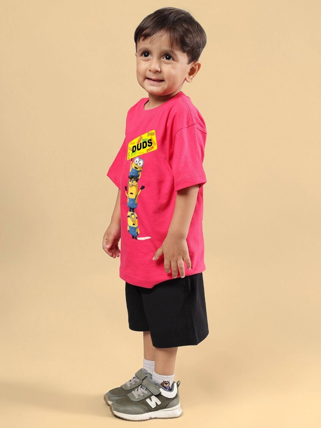 Child wearing Minion cartoon co-ord set in pink-black; features a playful Minion print T-shirt and comfortable shorts.