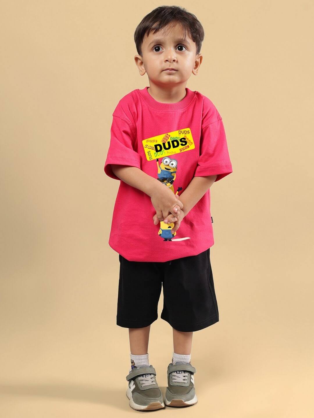 Child wearing Minion Cartoon Co-ord for Boys and Girls Pink-Black outfit, featuring pink top with Minion design and black shorts.