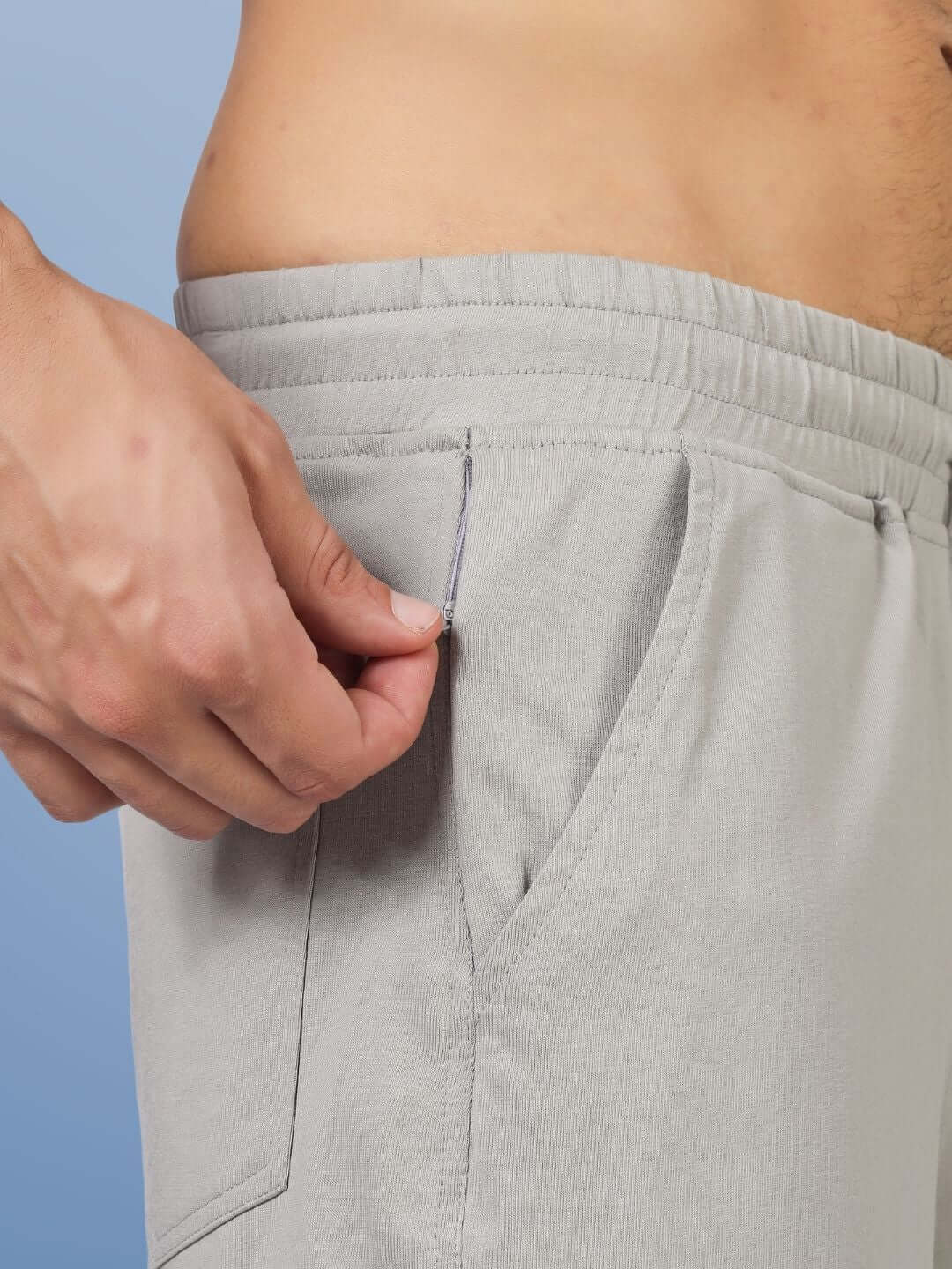 Close-up of grey Moaning Tigress regular fit shorts with elastic waistband and pocket detail.