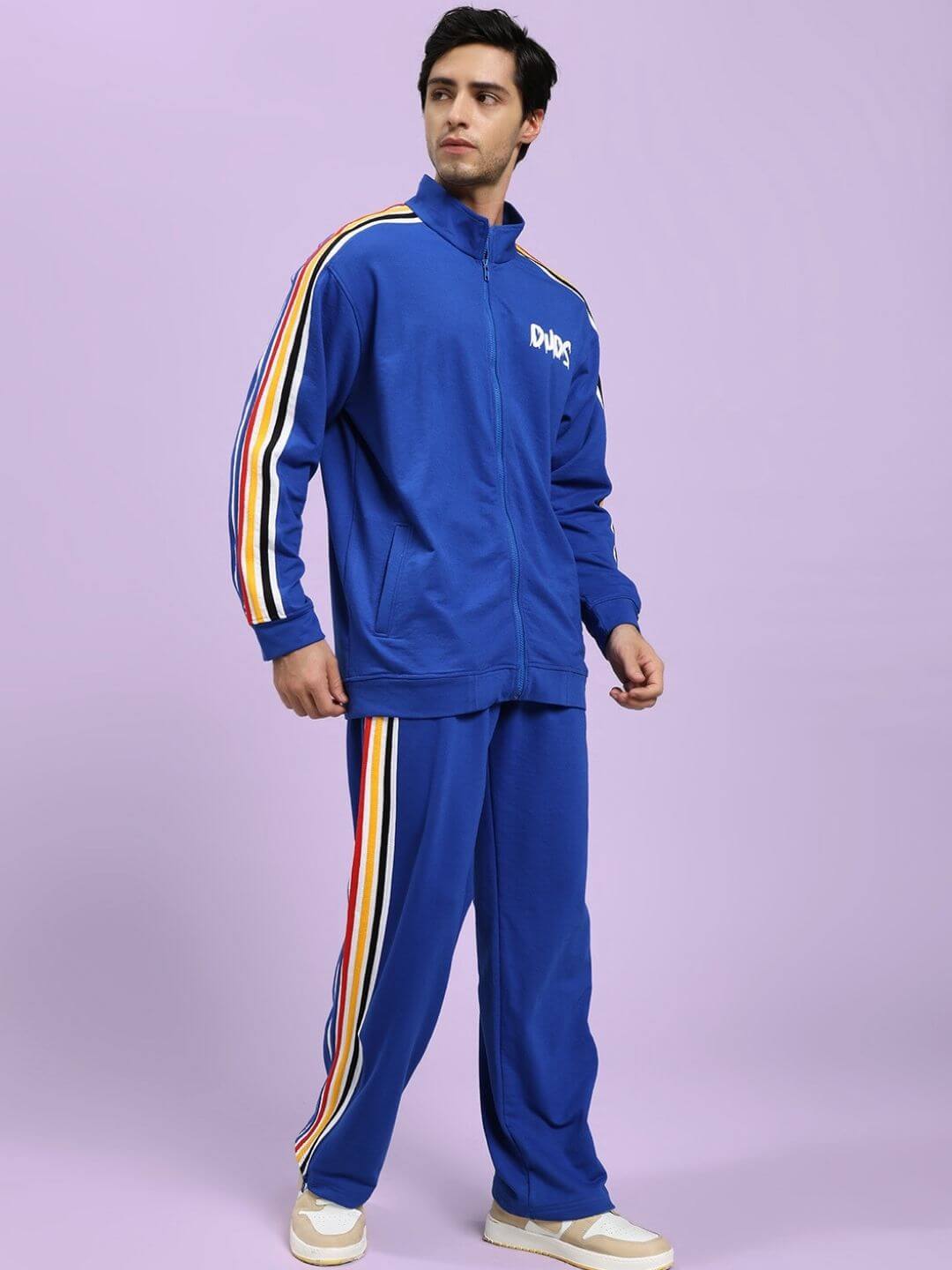 Man wearing MODERN EDGE MULTI-STRIPE CO-ORD SET ROYAL BLUE, featuring vibrant stripes and modern design, perfect for athletic style.