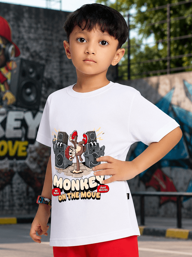 MONKEY BEATS T-SHIRT FOR BOYS GIRLS WHITE worn by a young boy with a playful monkey graphic in a vibrant outdoor setting.