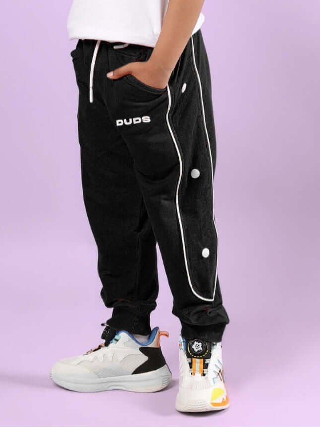 Child wearing MOON NIGHT JOGGER FOR BOYS & GIRLS BLACK by WEAR DUDS, showcasing stylish and comfortable streetwear for kids.