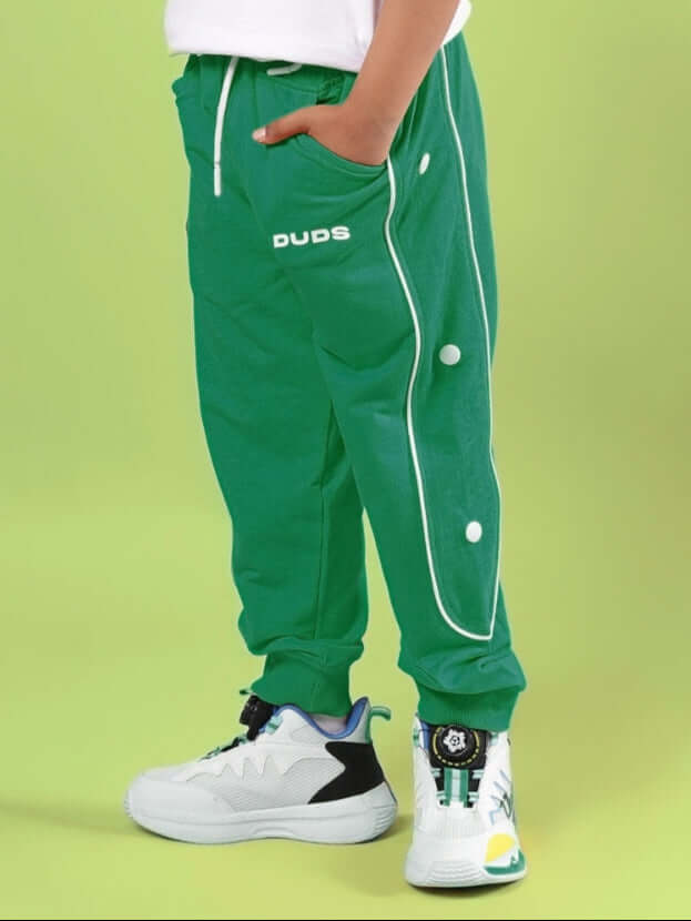 Child wearing MOON NIGHT JOGGER FOR BOYS & GIRLS GREEN by WEAR DUDS, showcasing trendy and comfortable streetwear.
