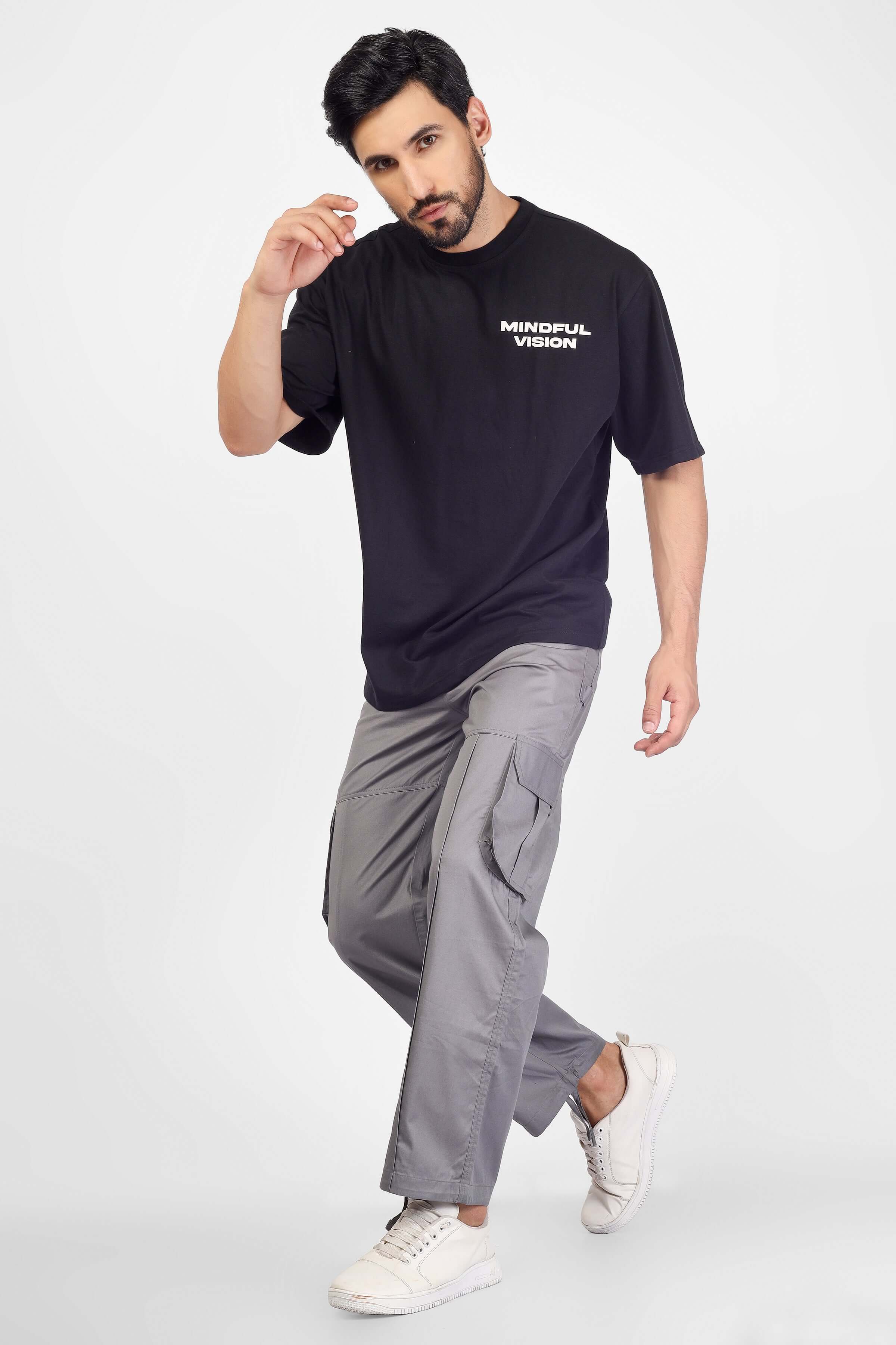Man modeling gray moon stone cargo pants with 6 pockets and a black t-shirt.