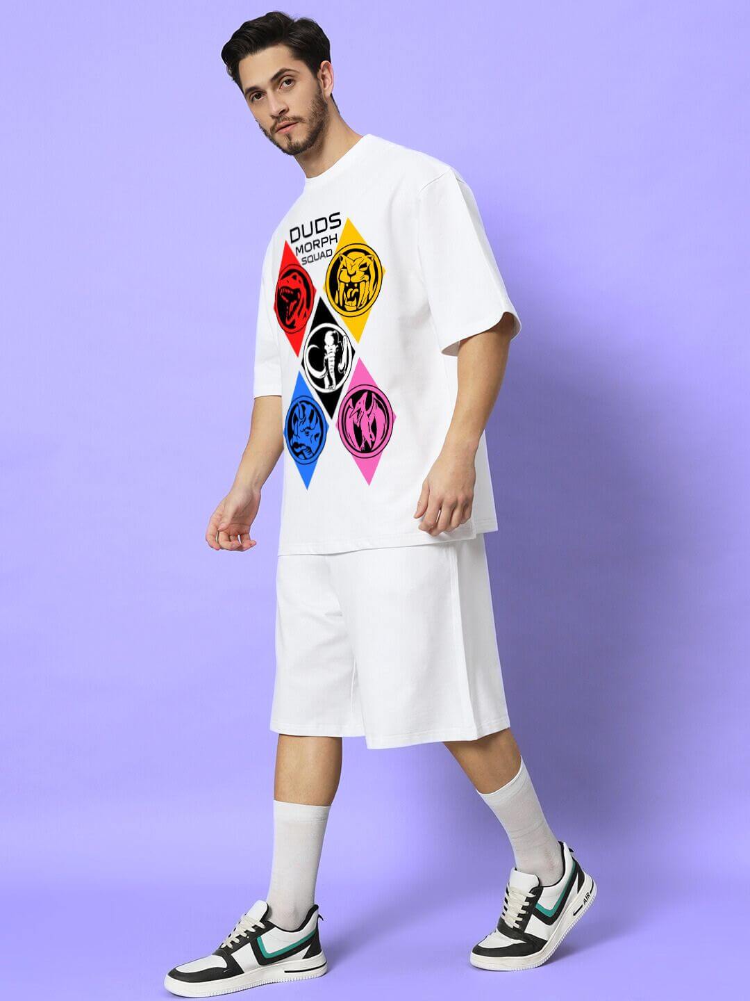 Model wearing MORPH SQUAD PRINTED CO-ORD SET WHITE against a purple background, showcasing bold street-style design and comfort.