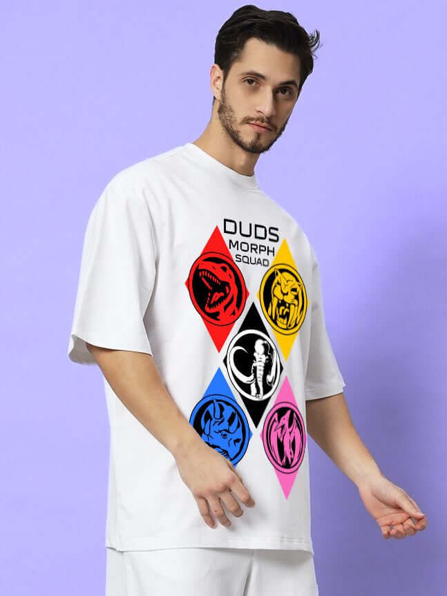 Man wearing MORPH SQUAD OVER-SIZED T-SHIRT WHITE with bold graphics, showcasing clean streetwear style against a purple background.