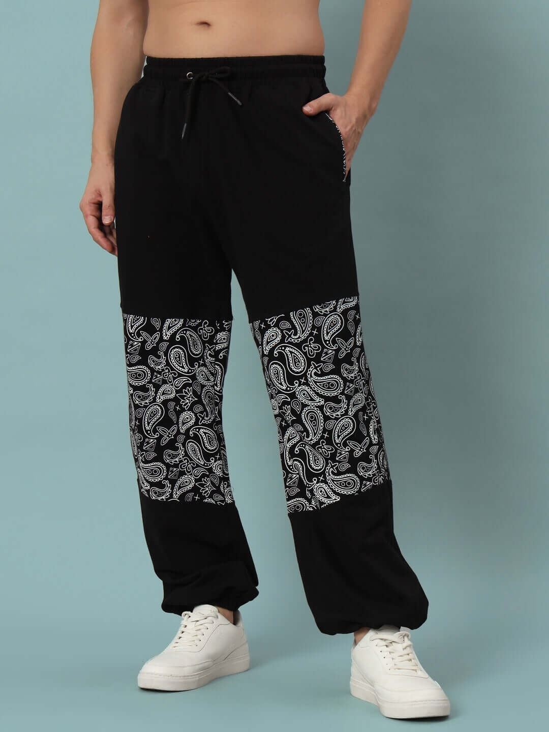 Black mosaic baggy joggers with paisley pattern, designed by DUDS, showcasing custom fit options and handcrafted quality.