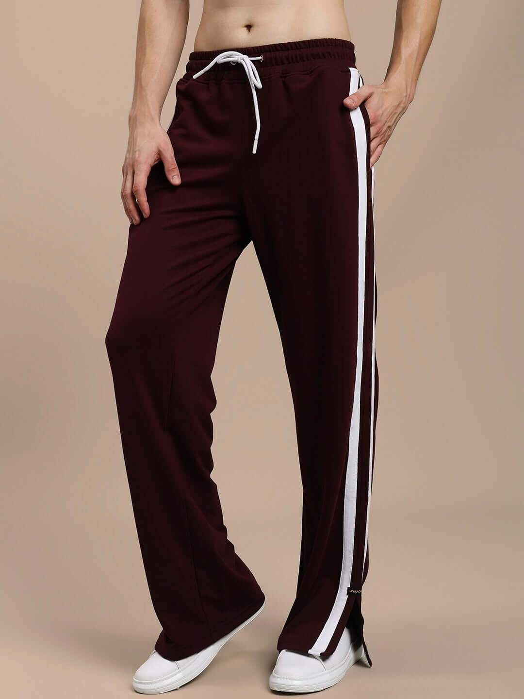 Maroon relaxed fit joggers with white side stripes, featuring adjustable drawstring waist.