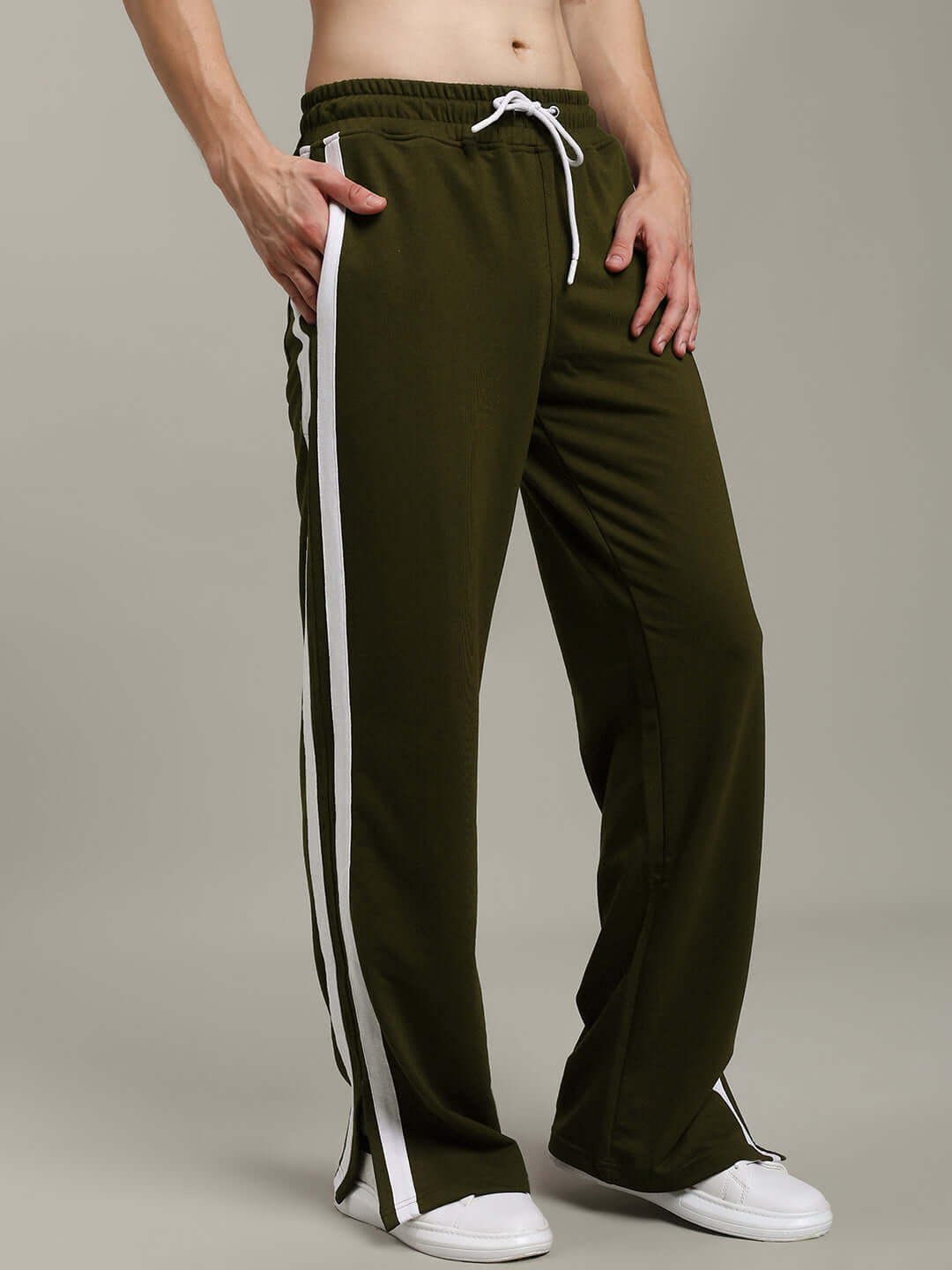 Olive green relaxed fit joggers with white side stripes, featuring an adjustable drawstring waist. Ideal for casual wear and comfort.