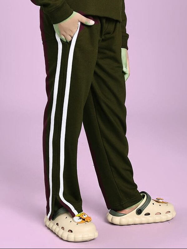 Child wearing MOSCOW RELAXED FIT JOGGER FOR BOYS AND GIRLS OLIVE GREEN with stripe detail and comfortable fit, suitable for everyday wear.