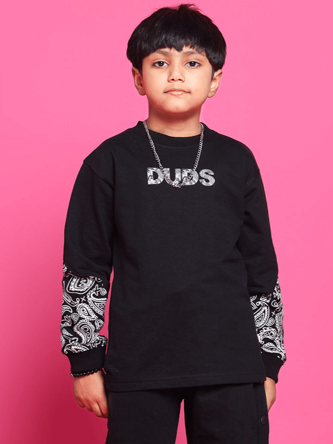 Boy wearing Motif Over-sized Sweatshirt in black with paisley design, made of 100% cotton, 240 GSM, bio-washed, ideal for boys and girls.