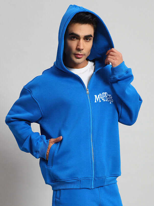 Man wearing a blue Muppet fleece co-ord set with hood.