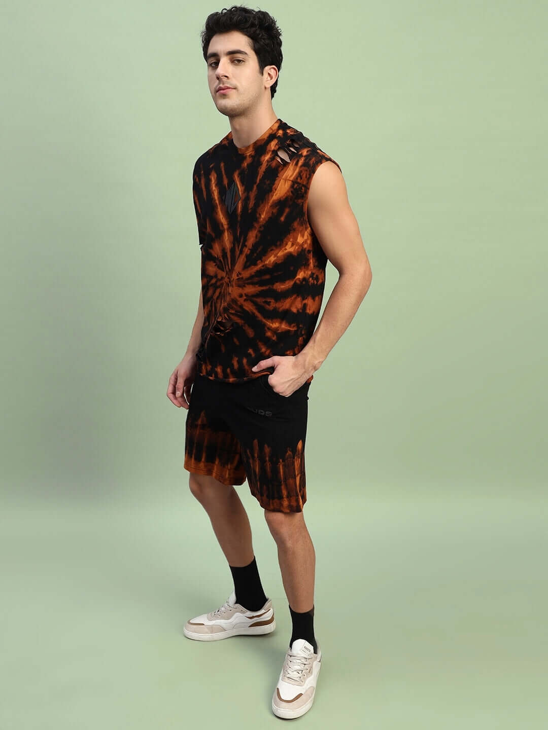 Model wearing black tie-dye muscle tee and ripped co-ord set, made from premium cotton terry and elastane. Stylish and comfortable.