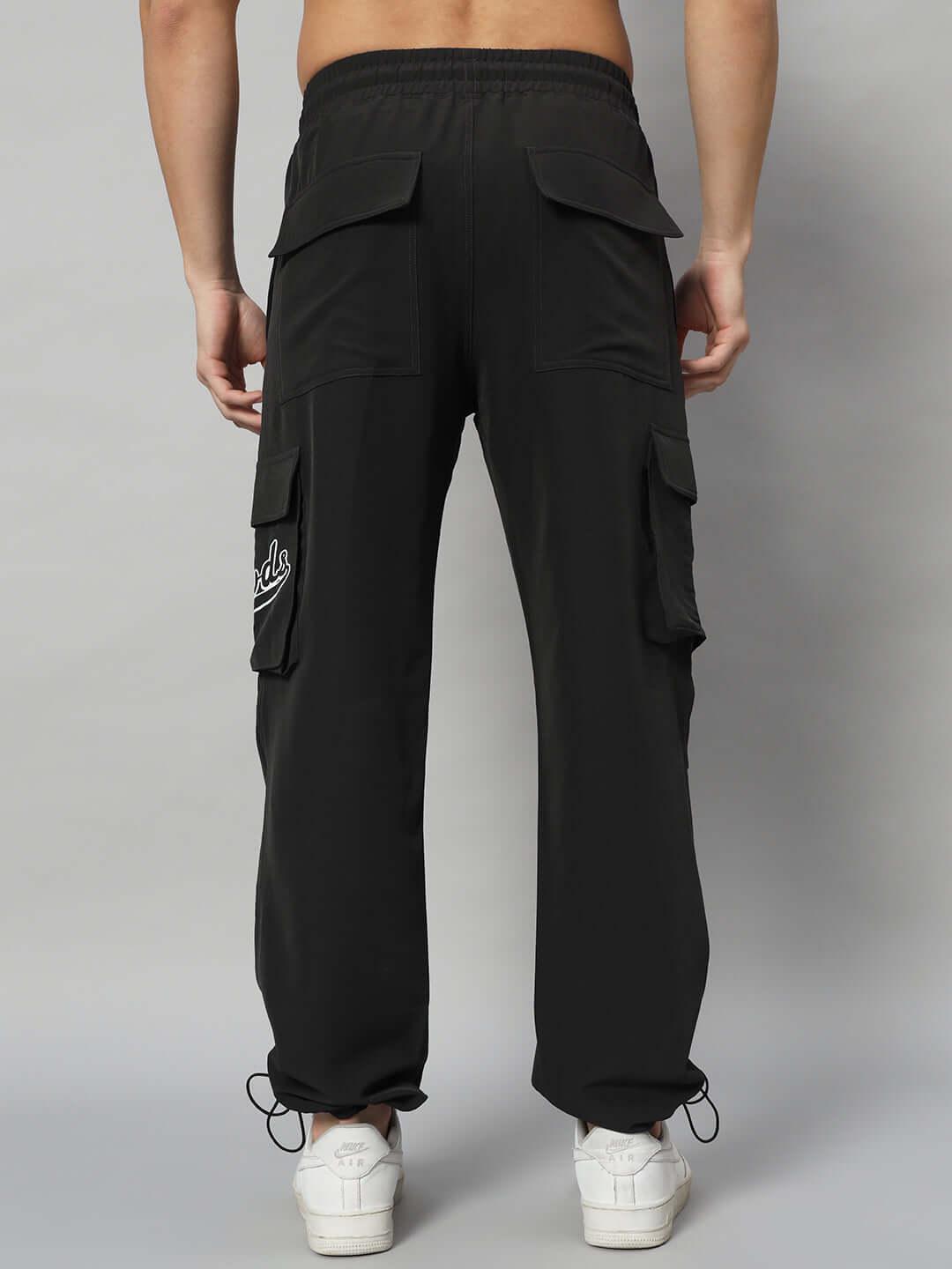 Back view of Myriad Relaxed Fit Cargo Pants in black, showcasing multiple pockets and a comfortable fit, suitable for custom size adjustments.