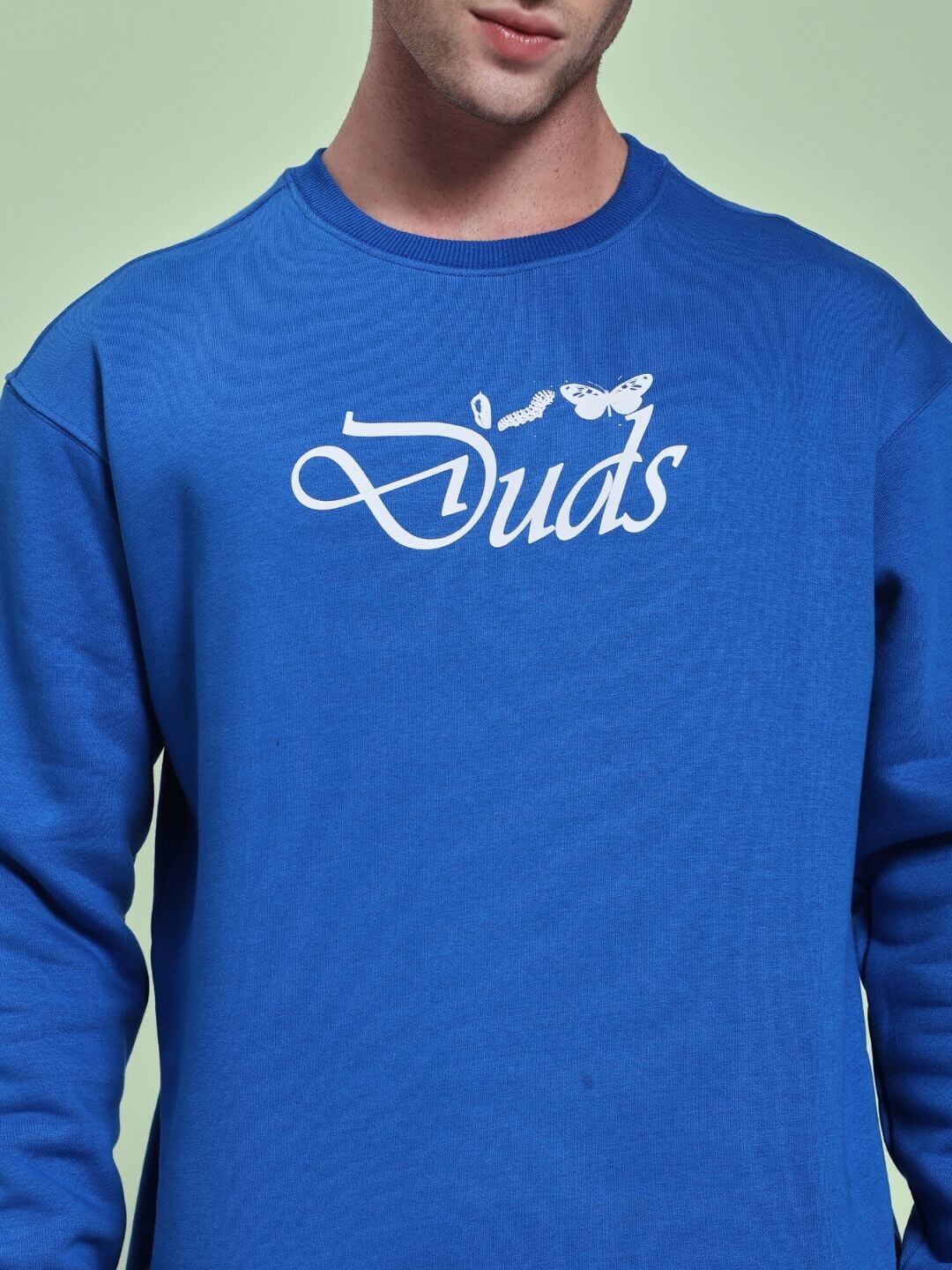 Model wearing NATURE LINK FLEECE CO-ORD SET ROYAL BLUE sweatshirt showcasing cozy, stylish design with printed logo.