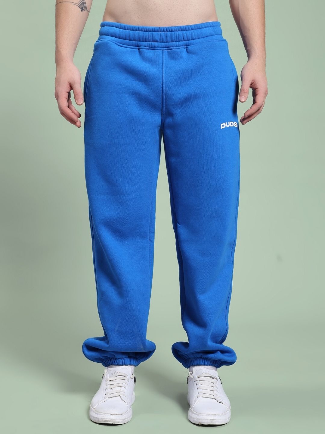 Person wearing NATURE LINK FLEECE JOGGER ROYAL BLUE showcasing the vibrant color and comfortable fit.