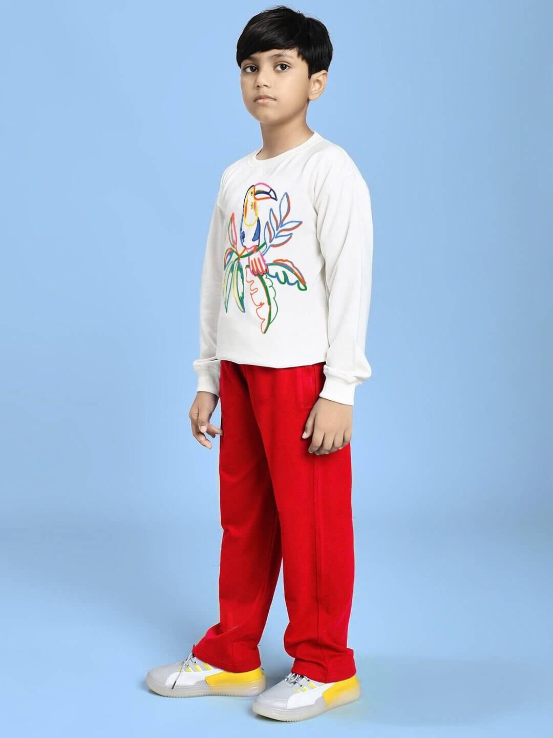 Child wearing NATURE VIBES BIRD PRINT CO-ORD FOR BOYS AND GIRLS WHITE RED outfit against a blue background