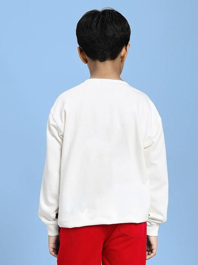 Back view of child wearing NATURE VIBES BIRD PRINT SWEATSHIRT FOR BOYS AND GIRLS WHITE, paired with red pants against a blue background