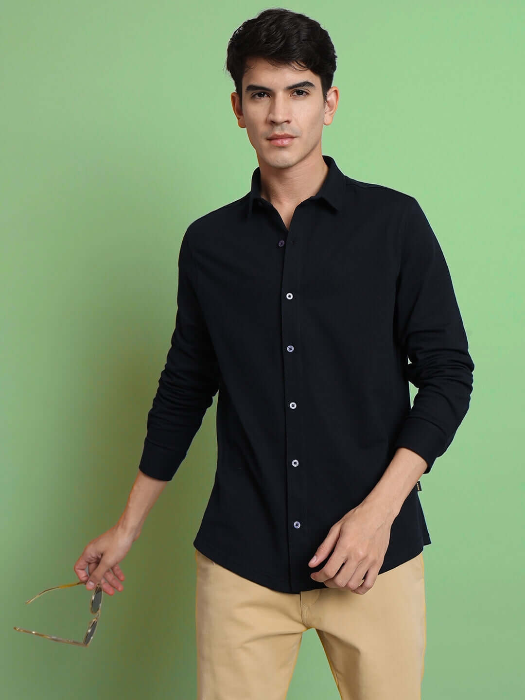 Model wearing a navy blue sporty pique shirt with full sleeves, showcasing slim fit and comfort. Ideal for all-day wear and wrinkle-free.