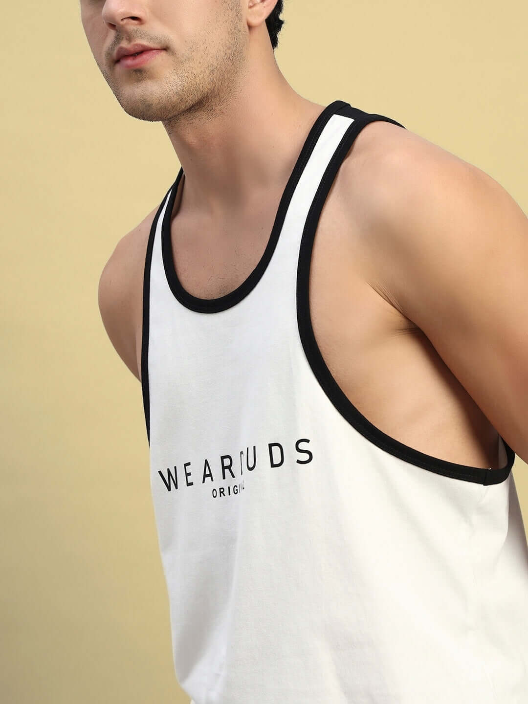 Model wearing NEO Gym T-shirt in off white with black trim, showcasing its fit and style; perfect for custom size orders with DUDS.