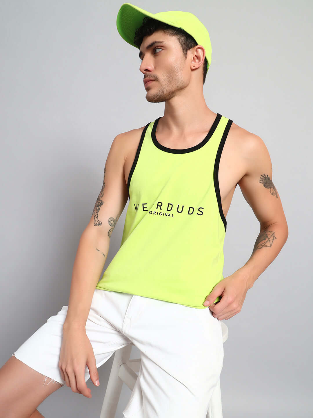 Model wearing NEO GYM T-SHIRT in neon green with black trim, showcasing modern fitness style by DUDS.