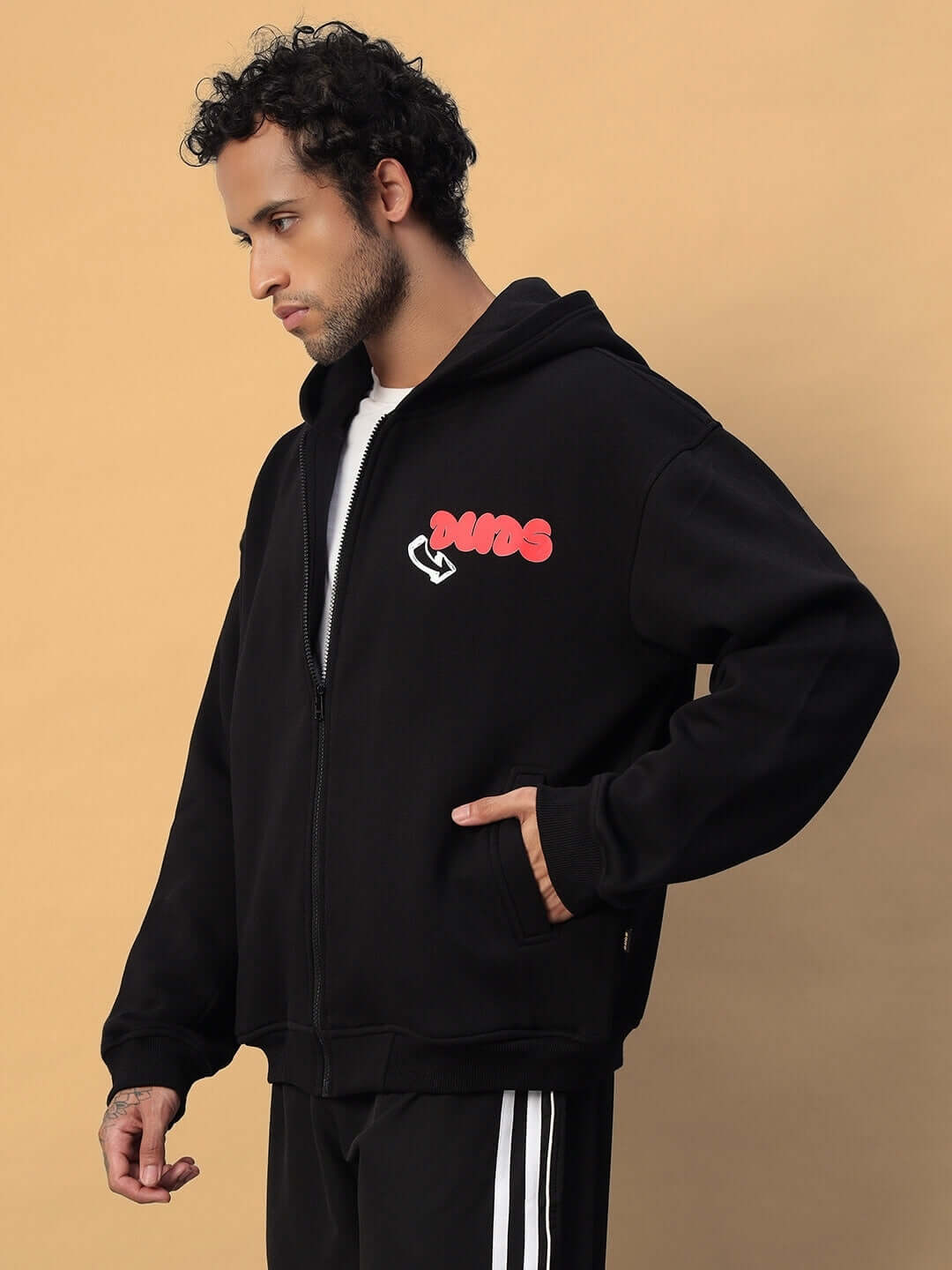 Model wearing NEVER BE AFRAID FLEECE HOODIE BLACK with bold graphic, depicting confidence and style in premium fleece fabric.