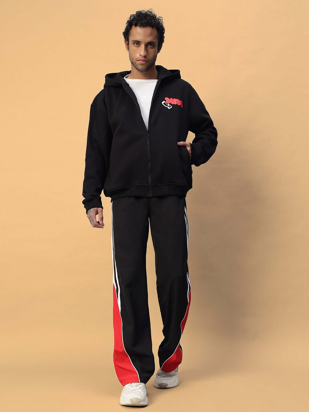 Man wearing NEVER BE AFRAID FLEECE HOODIE BLACK with red and white stripe pants