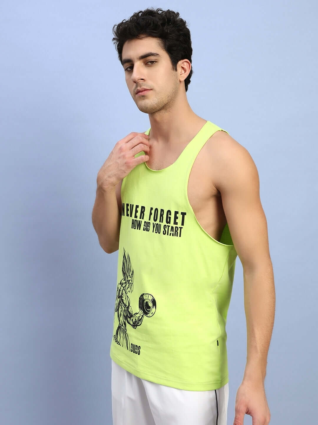 Man wearing neon green gym tank top with 'Never Forget' print, ideal for workouts. Custom fit options available for prepaid orders.