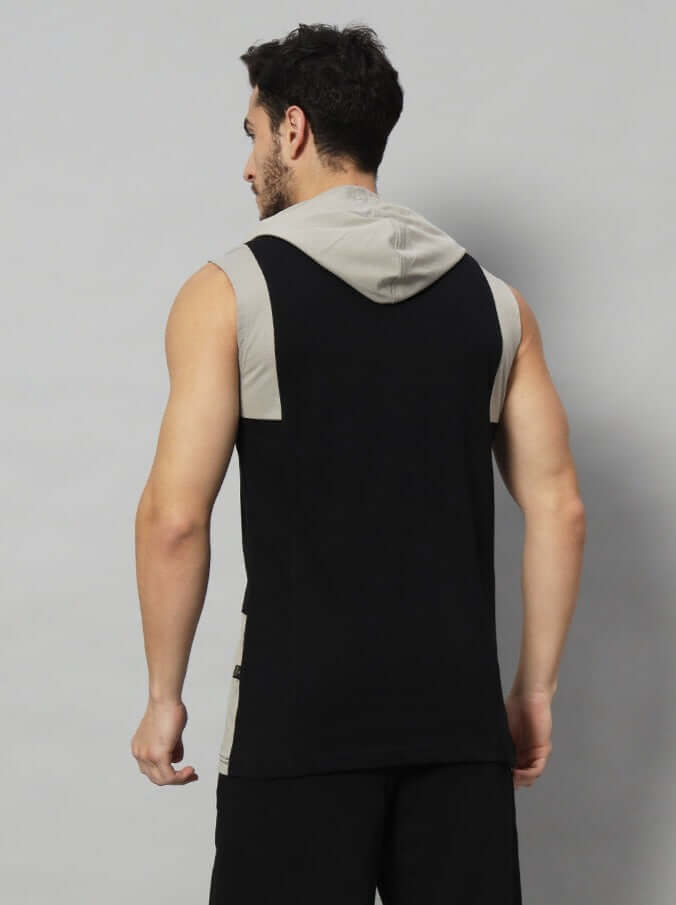 Man wearing NEVER STOP grey-black gym t-shirt with hoodie, viewed from the back, showcasing athletic fit and design.