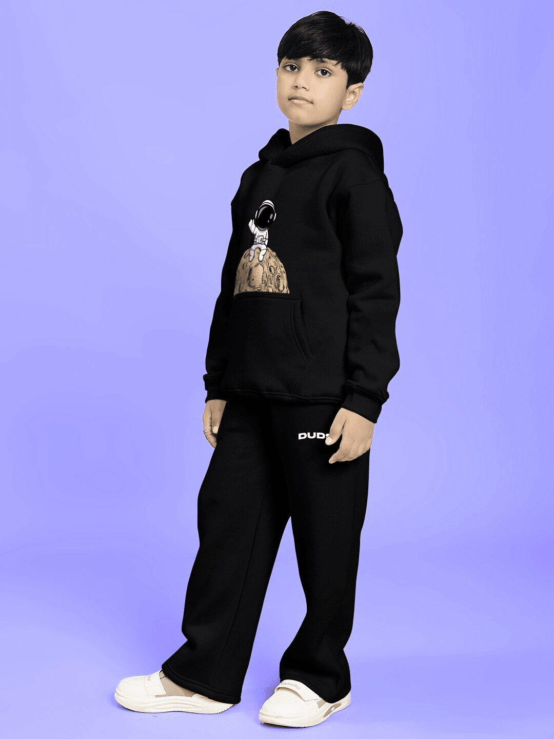 NEXT TO A MOON FLEECE CO-ORD FOR BOYS AND GIRLS BLACK modeled by a child in cozy and stylish black outfit.