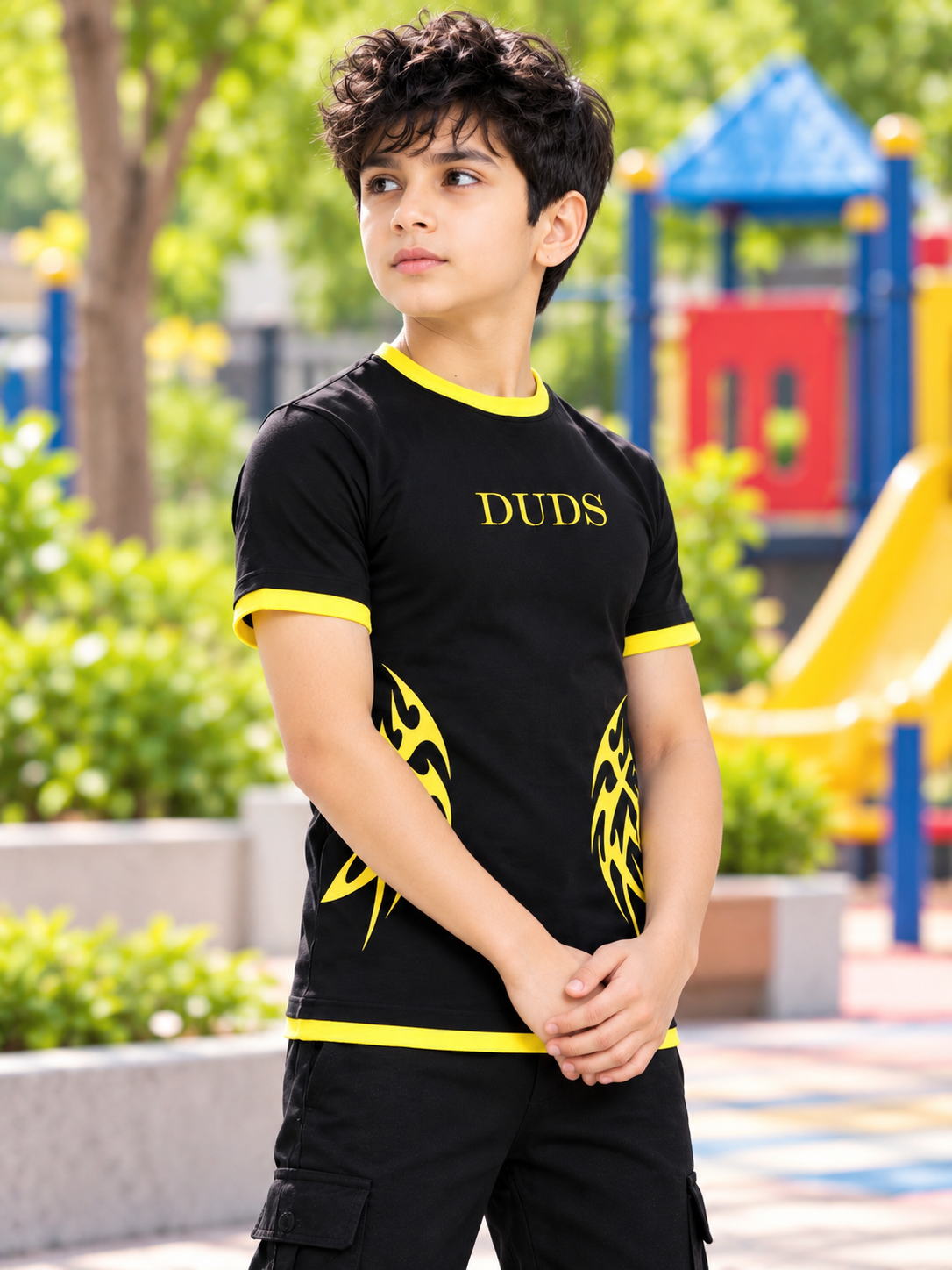 NIMO REGULAR FIT T-SHIRT FOR BOYS GIRLS BLACK with yellow flame graphic, worn by boy at playground