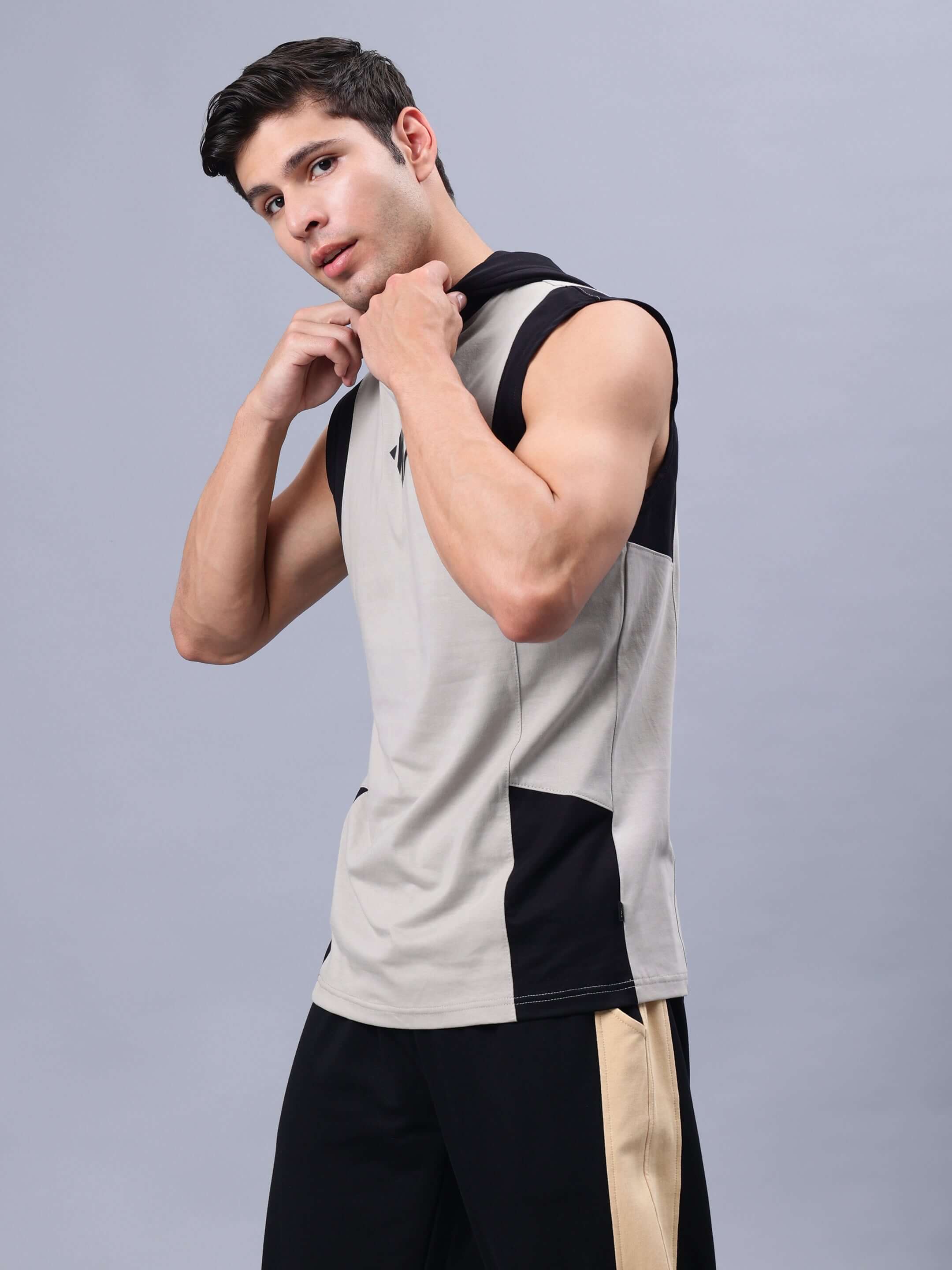 Man wearing Nirvana Gym T-Shirt in grey-black, showcasing the sleeveless design, ideal for workouts, customizable fit available.