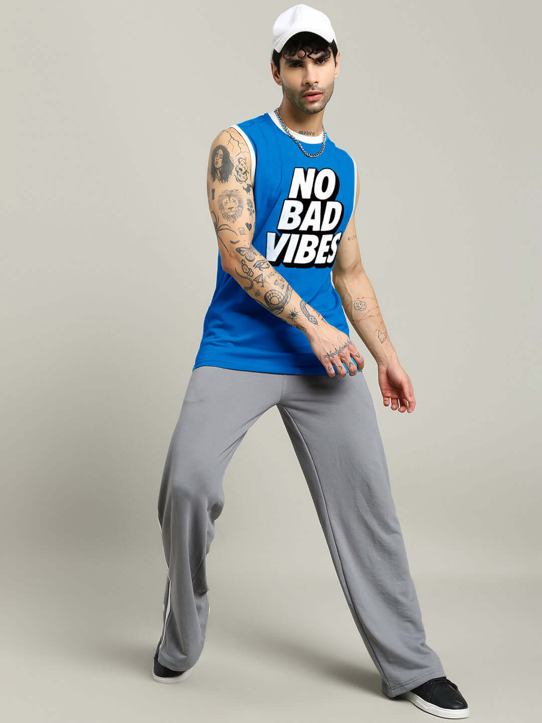 Athlete wearing NO BAD VIBES SLEEVLESS GYM T-SHIRT BLUE during an energetic workout session.