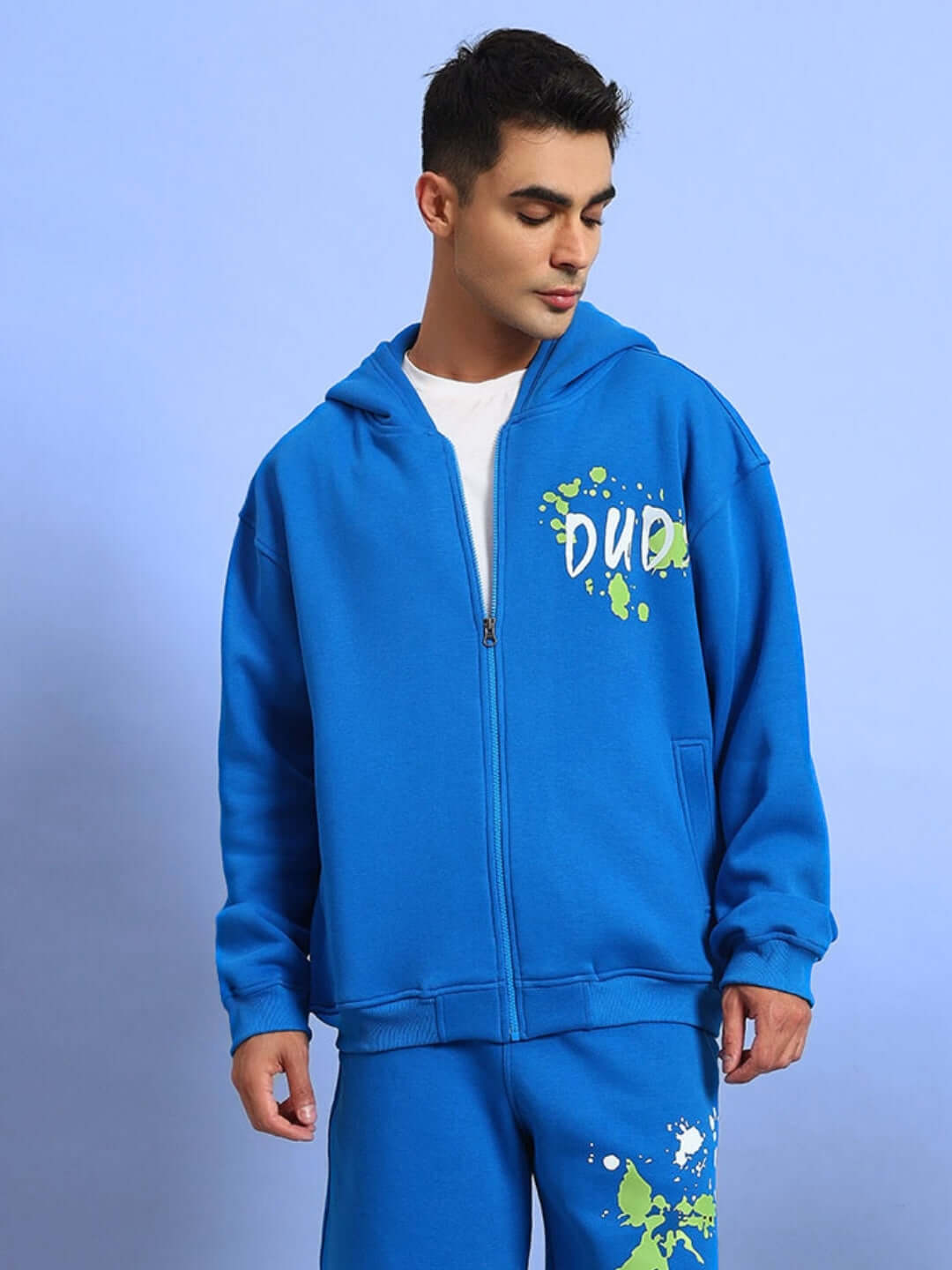 Man wearing a blue fleece hoodie with 'Dude' print, part of the No Drama Cotton Fleece collection.