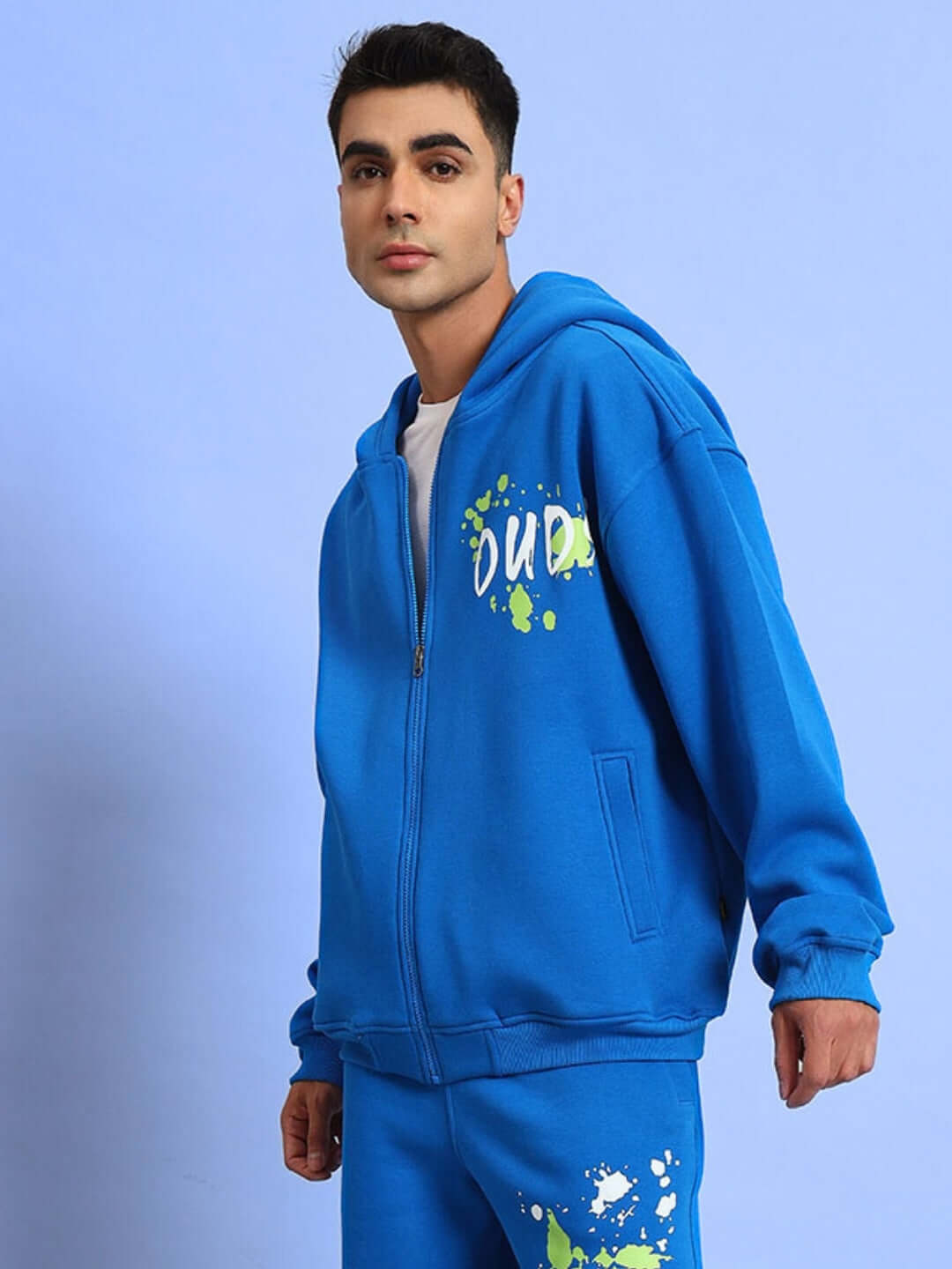 Man wearing No Drama cotton fleece hoodie in vibrant royal blue with colorful graphic print, perfect casual wear for comfort and style.