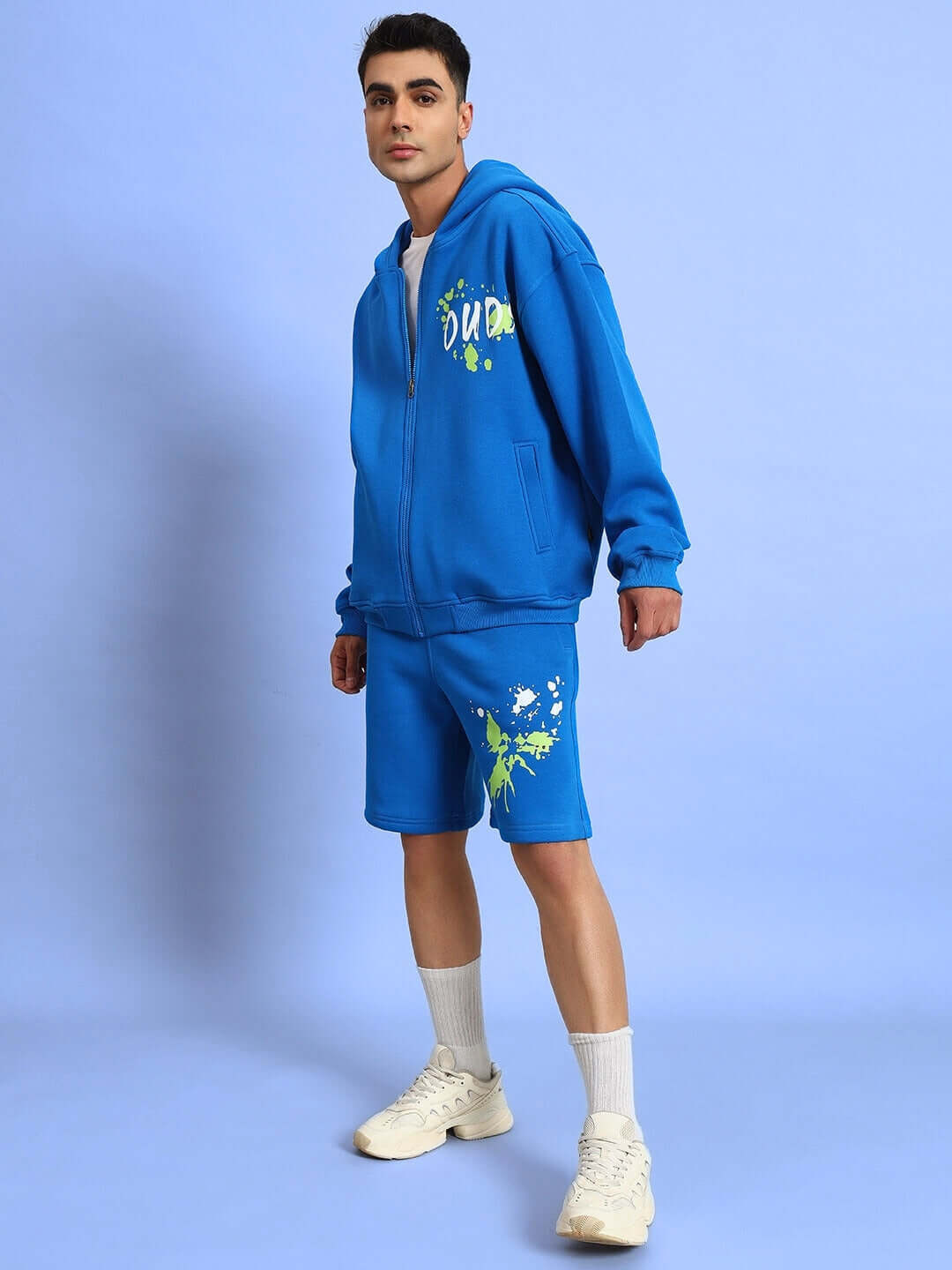 Man wearing NO DRAMA COTTON FLEECE SHORTS ROYAL BLUE with matching hoodie, showcasing casual streetwear style and comfort.