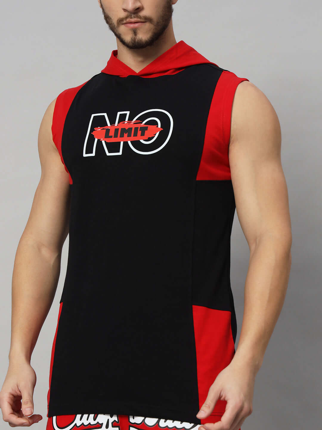 Man wearing a red-black NO LIMIT GYM regular t-shirt, available in customizable sizes with prepaid options for a perfect fit.