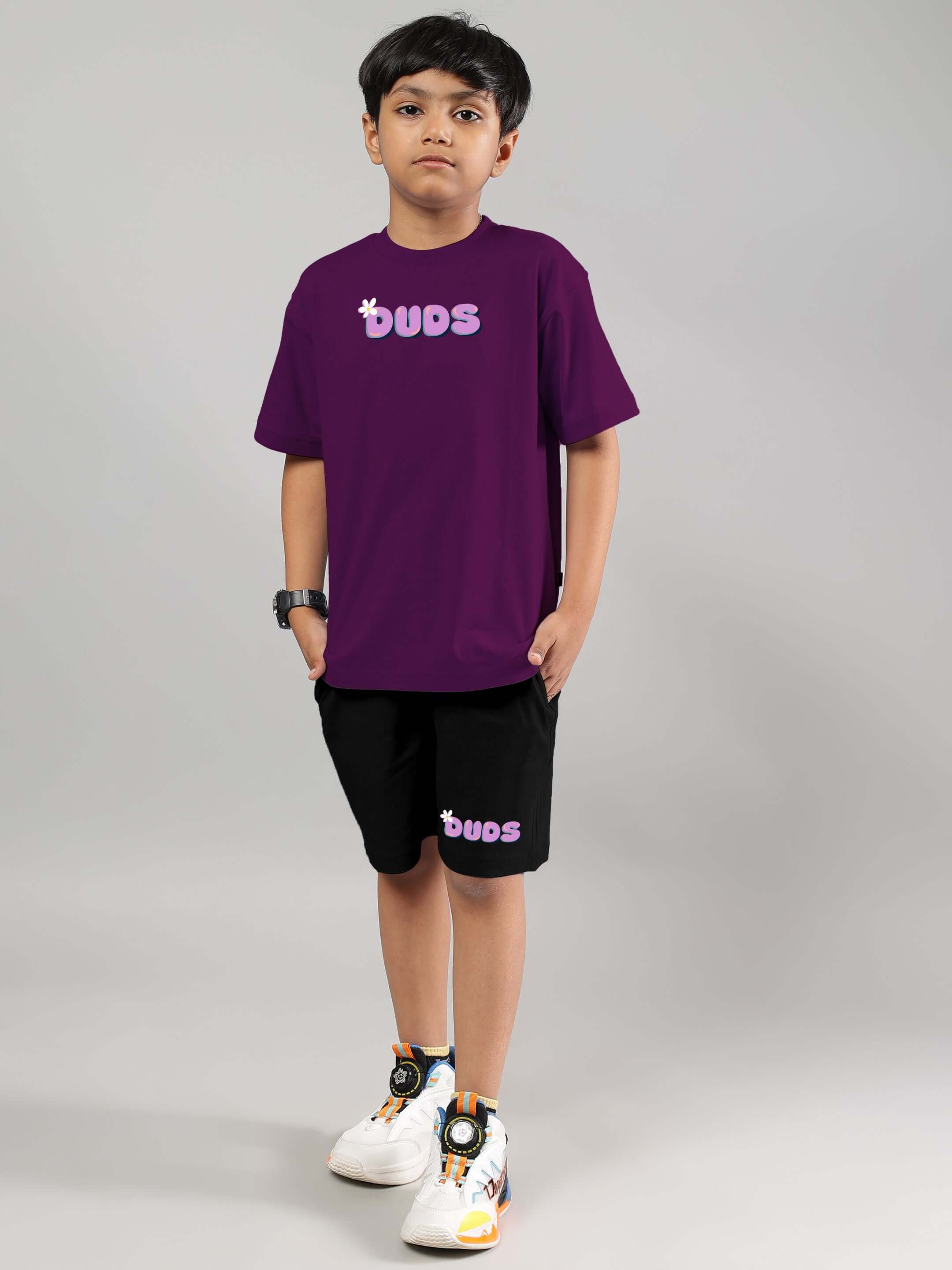 Child wearing purple-black NO POS WOW co-ord set by DUDS, customizable fit available, made to order with tailored precision.