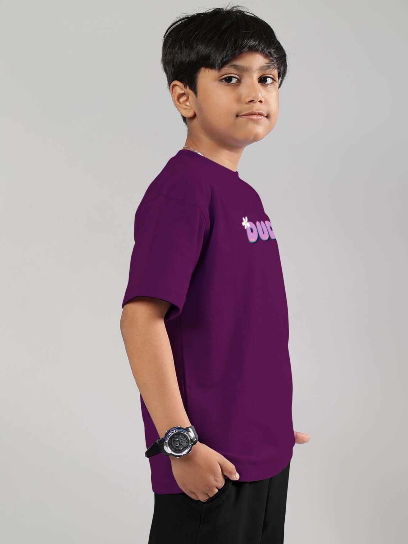 Child wearing a purple 'NO POS WOW' t-shirt from DUDS, showcasing casual style for boys and girls.