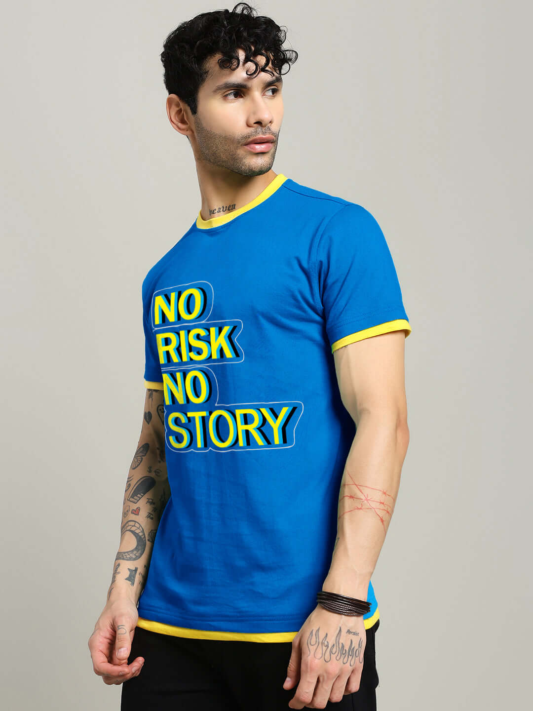 Model wearing NO RISK PRINTED REGULAR FIT T-SHIRT ROYAL BLUE with bold text design and yellow accents.