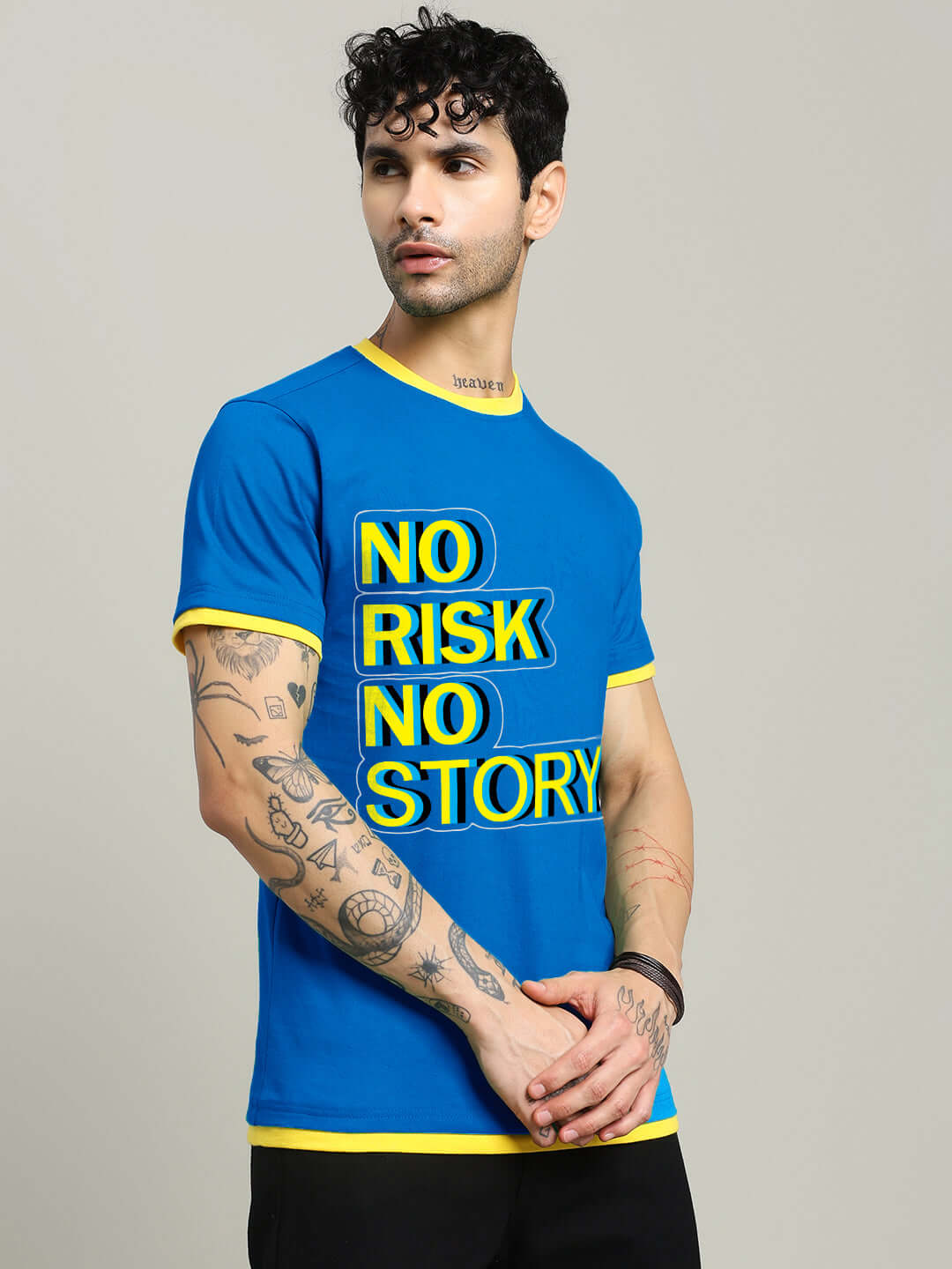 Man wearing NO RISK PRINTED REGULAR FIT T-SHIRT ROYAL BLUE with yellow trim, showcasing bold text design.