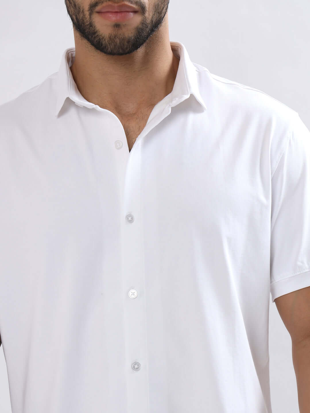 NOIR white shirt half sleeves, wrinkle-free, slim fit, curved hem, worn by model; 100% cotton Lycra, superior stretch, comfortable.