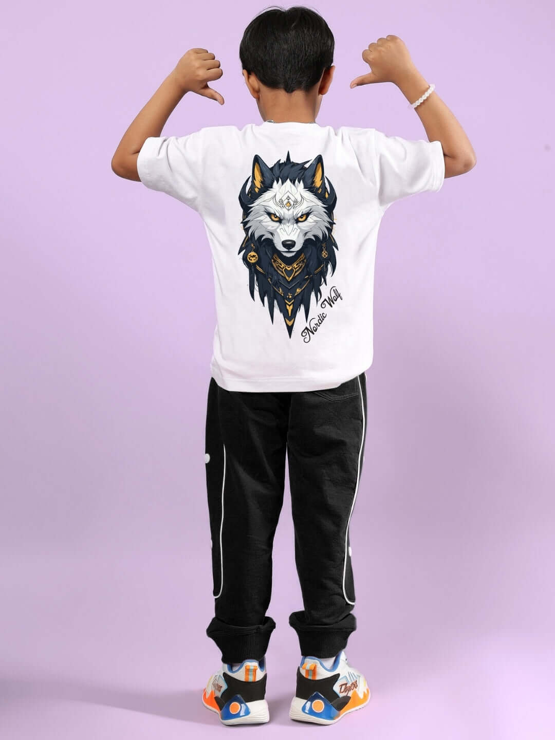 Child wearing Nordic Wolf Co-Ord set in white-black from DUDS, showcasing a wolf graphic design on the back of the shirt.