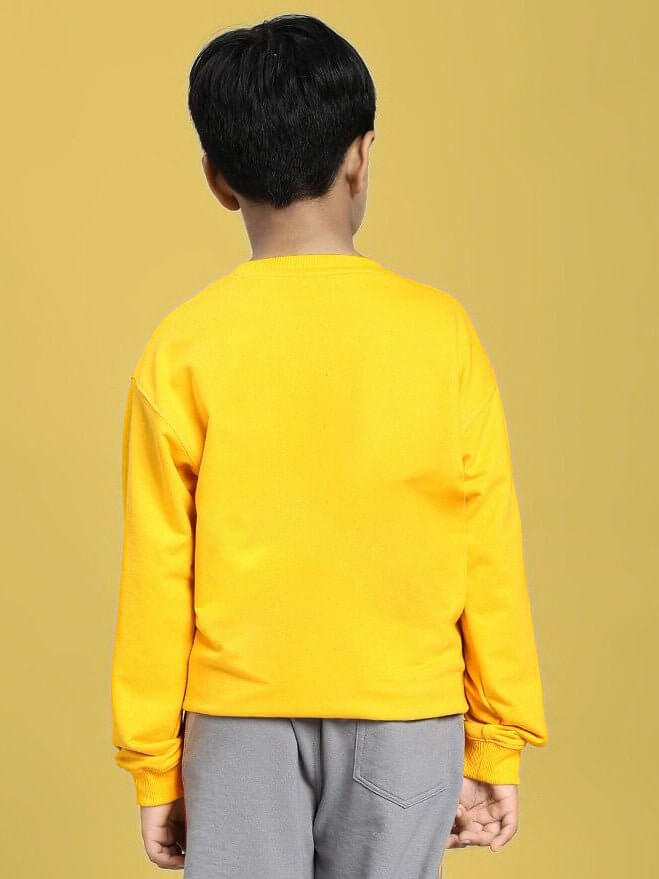 Child wearing NOT FAST BUT FURIOUS PRINT SWEATSHIRT BOYS AND GIRLS YELLOW, showcasing back view.
