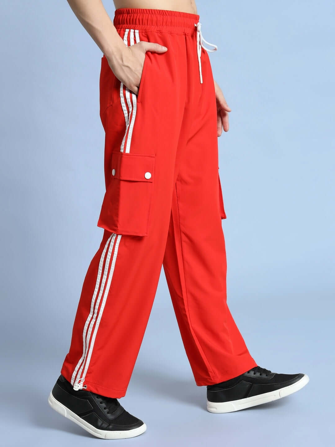 NOVA RELAXED FIT CARGO PANTS RED with side pockets in vibrant red and white stripes, showcasing streetwear style and comfort.
