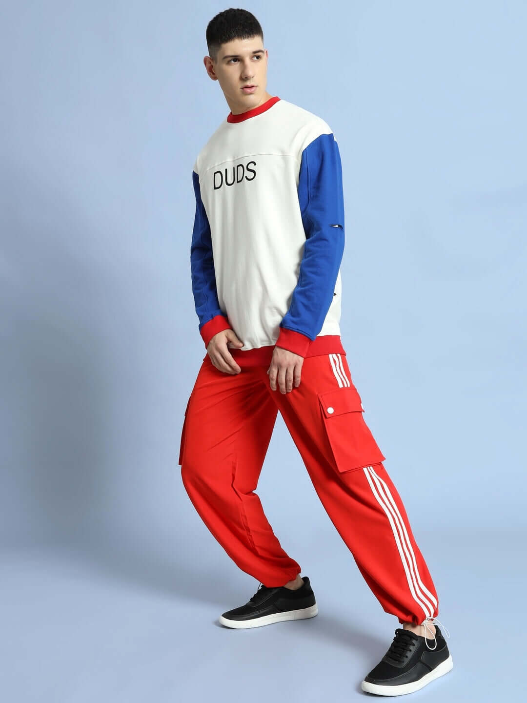 Model wearing Nova Relaxed Fit Cargo Pants Red, stylish streetwear with vibrant hue and cargo pockets